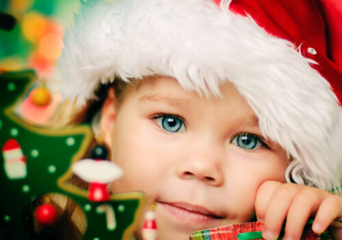Happy small girl in santa hat with lot of gift have a christmas